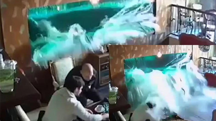 咖啡店巨型鱼缸爆裂瞬间曝光 两男子猝不及防遭洪水袭面漫身