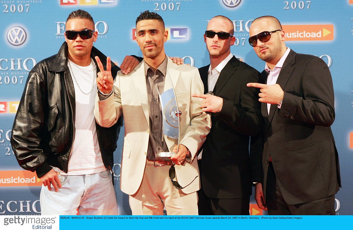berlin - march 25:  singer bushido (c) holds his award for best 