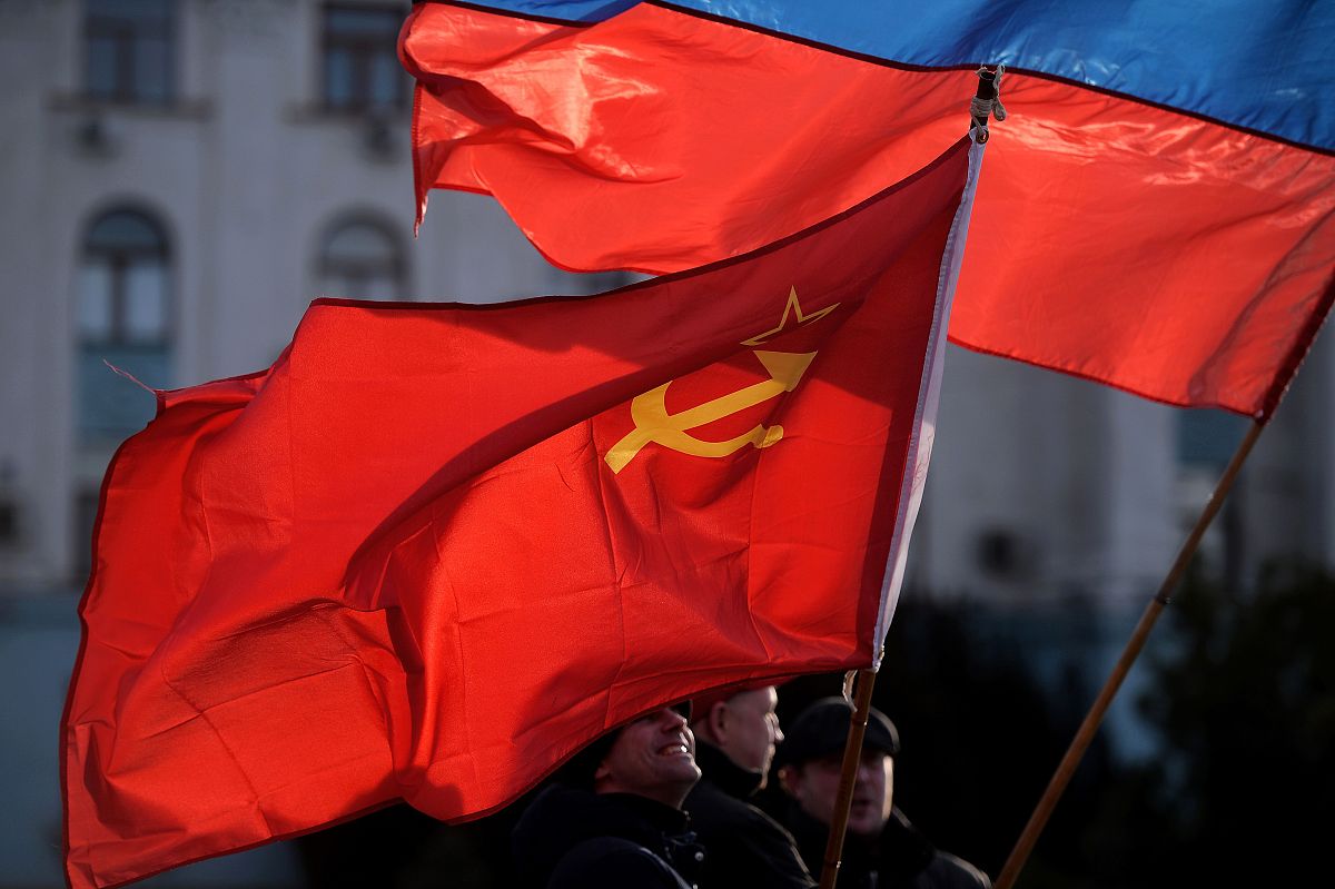 men hold russian (top r) and soviet union flags in simferopol's 