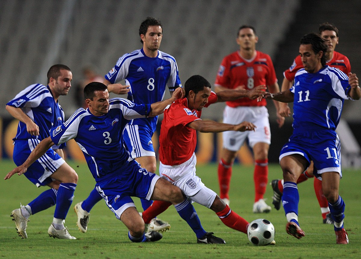 england's theo walcott (c) gets outnumbered by andorra's xavi an