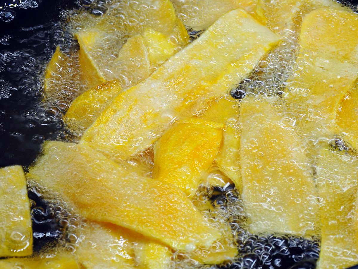 图为香脆地瓜片的制作过程 起锅烧油,油温5成热,转中火保持住火力,将