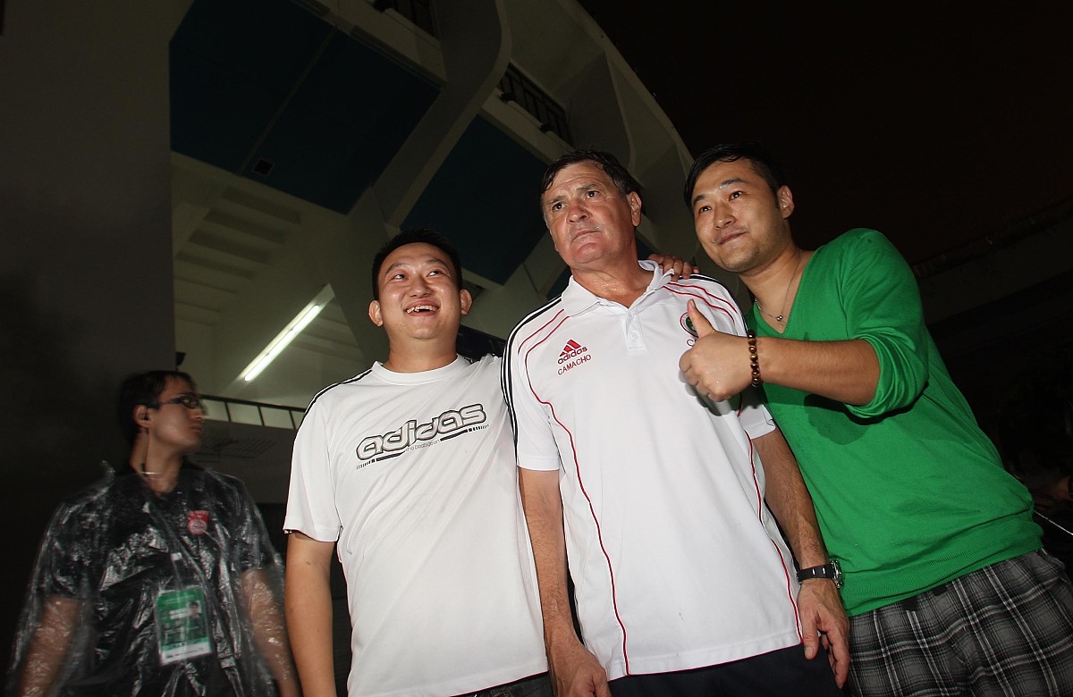 卡马乔被球迷拉着合影***_***2011年10月10日,深圳,2014世界杯亚洲区