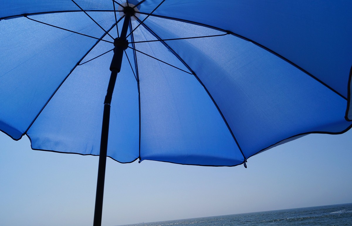 blue umbrella by the sea.