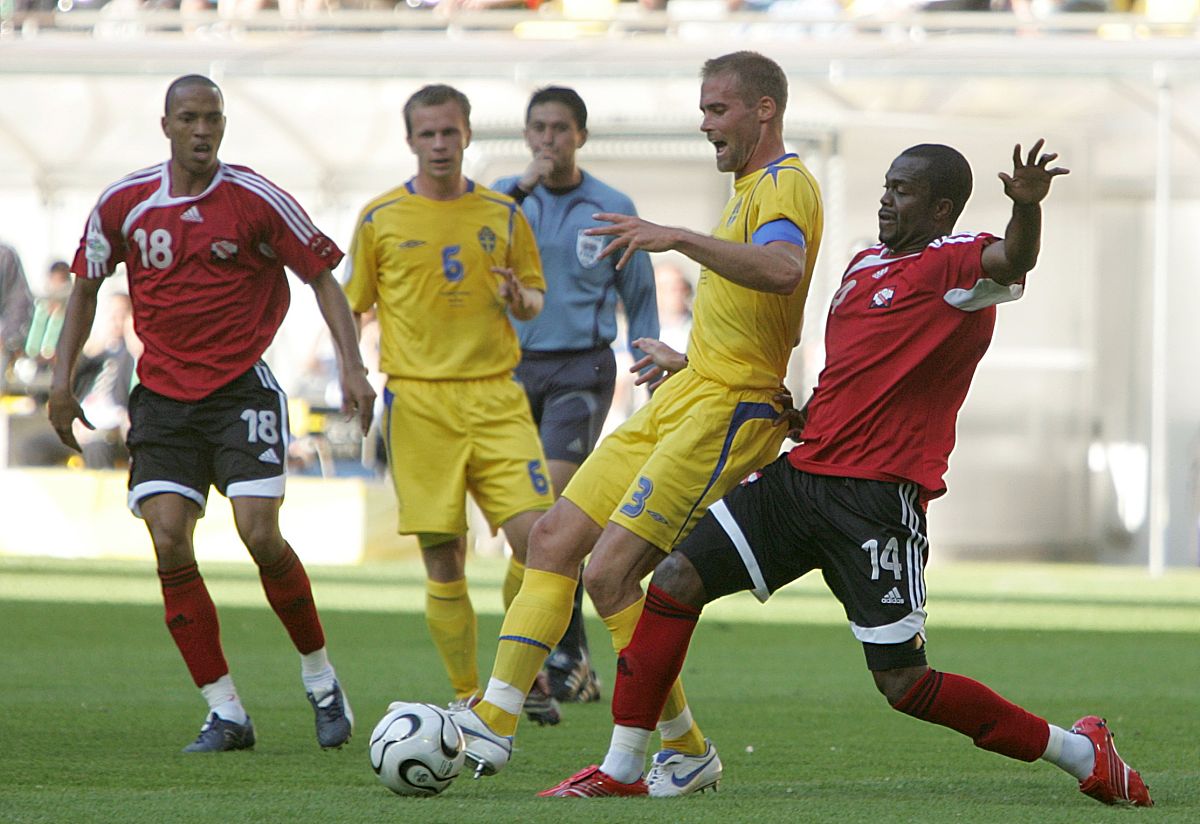 sweden's olof mellberg is fouled by trinidad and tobago's stern 