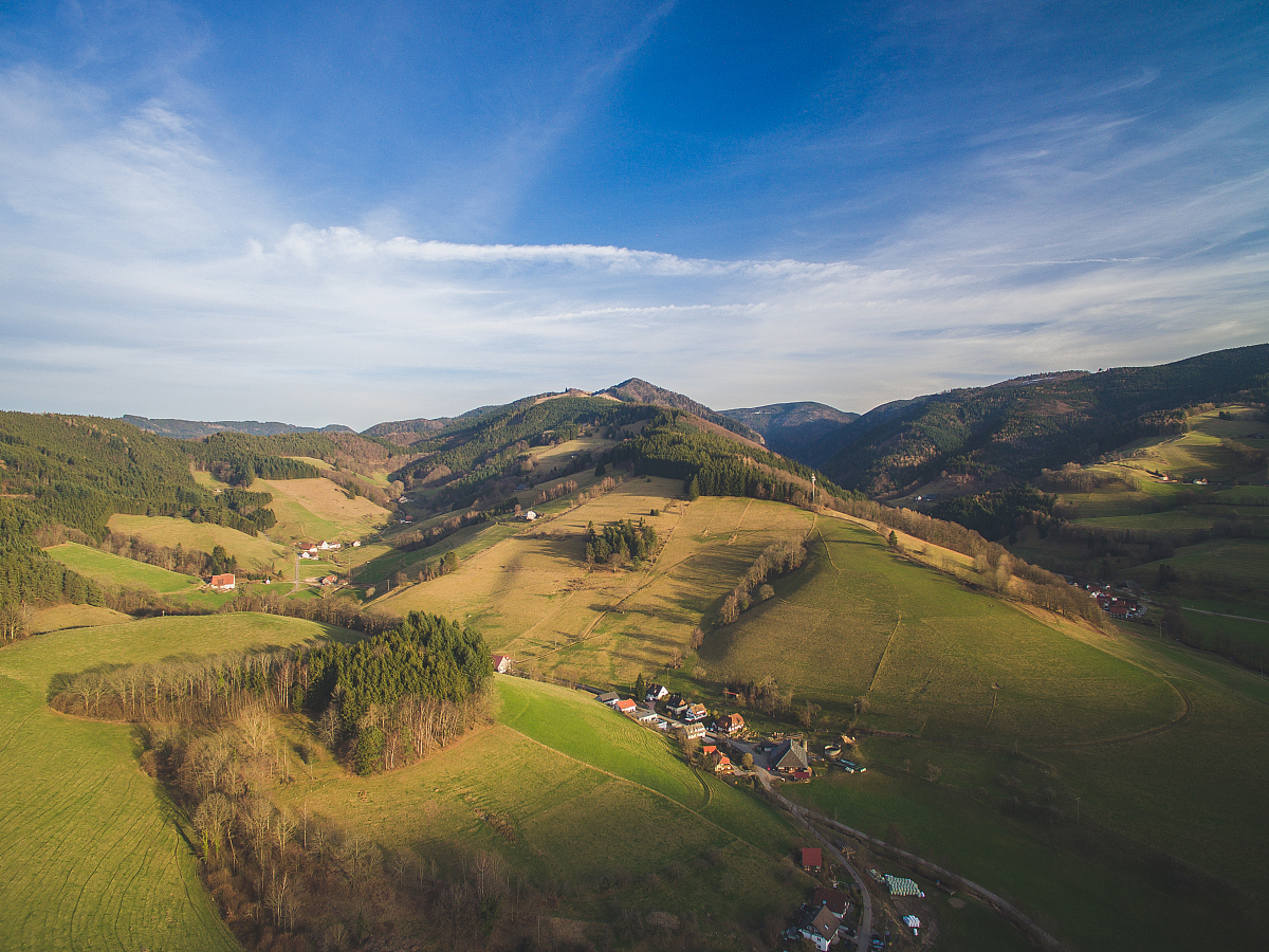 aerial view of magnificent landscape with houses between hills, 