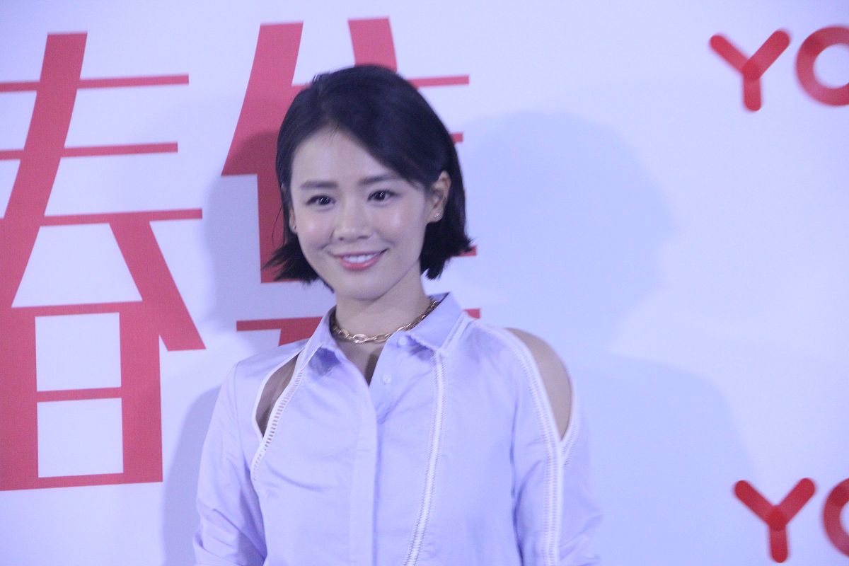马思纯身穿浅蓝色镂空衬衫,下穿黑色拉链绑带高腰皮裙,脚踩粉色麂皮亮
