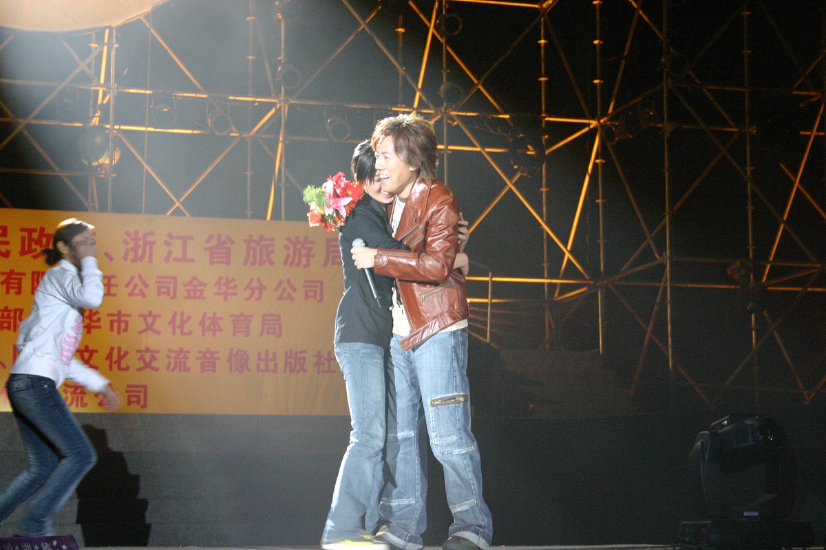 2004年11月6日,著名歌星张宇在金华表演中被女歌迷紧紧拥抱.+++_+++张