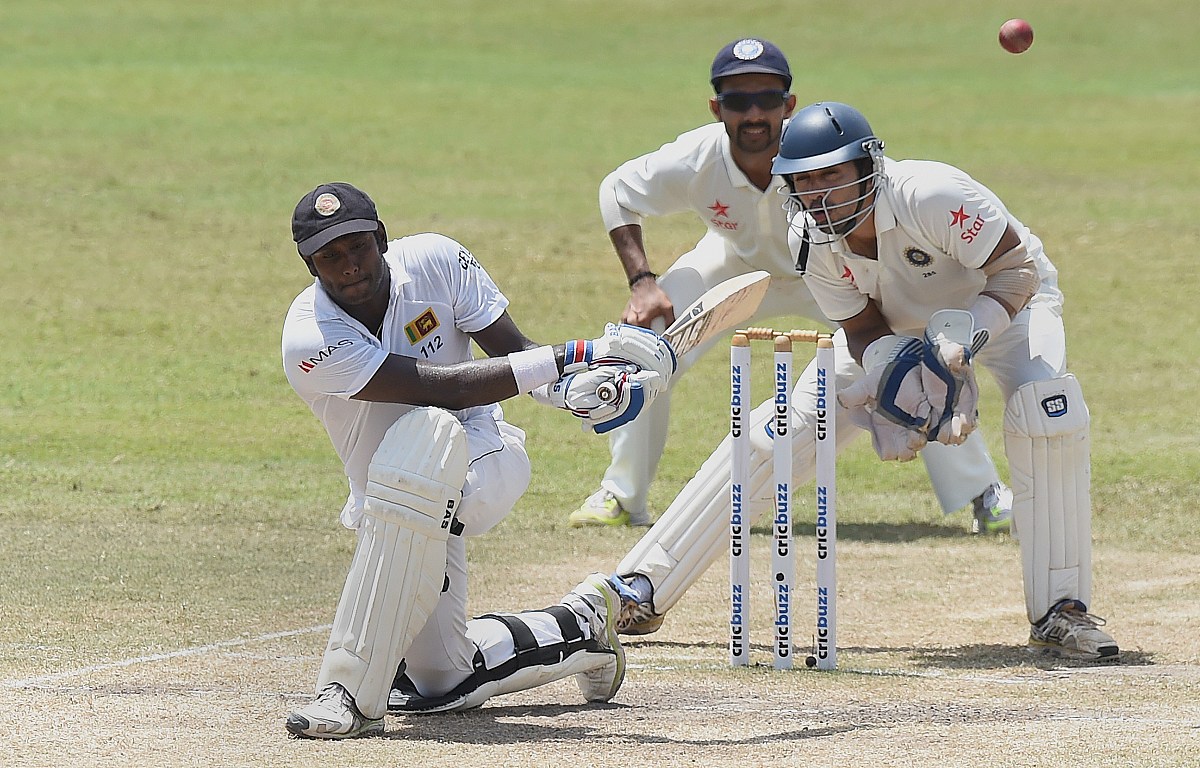 sri lankan captain angelo mathews (l) plays a shot as indian wic