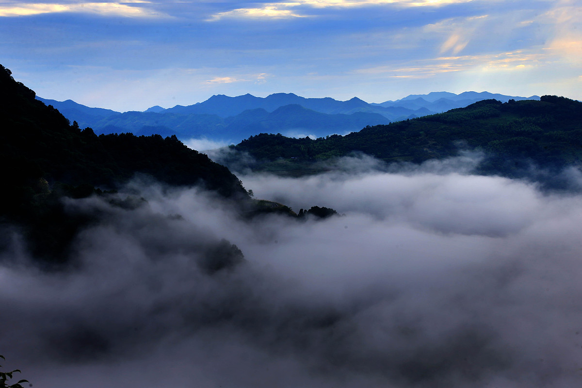 请用100字形容一下云雾缭绕在群山的场景