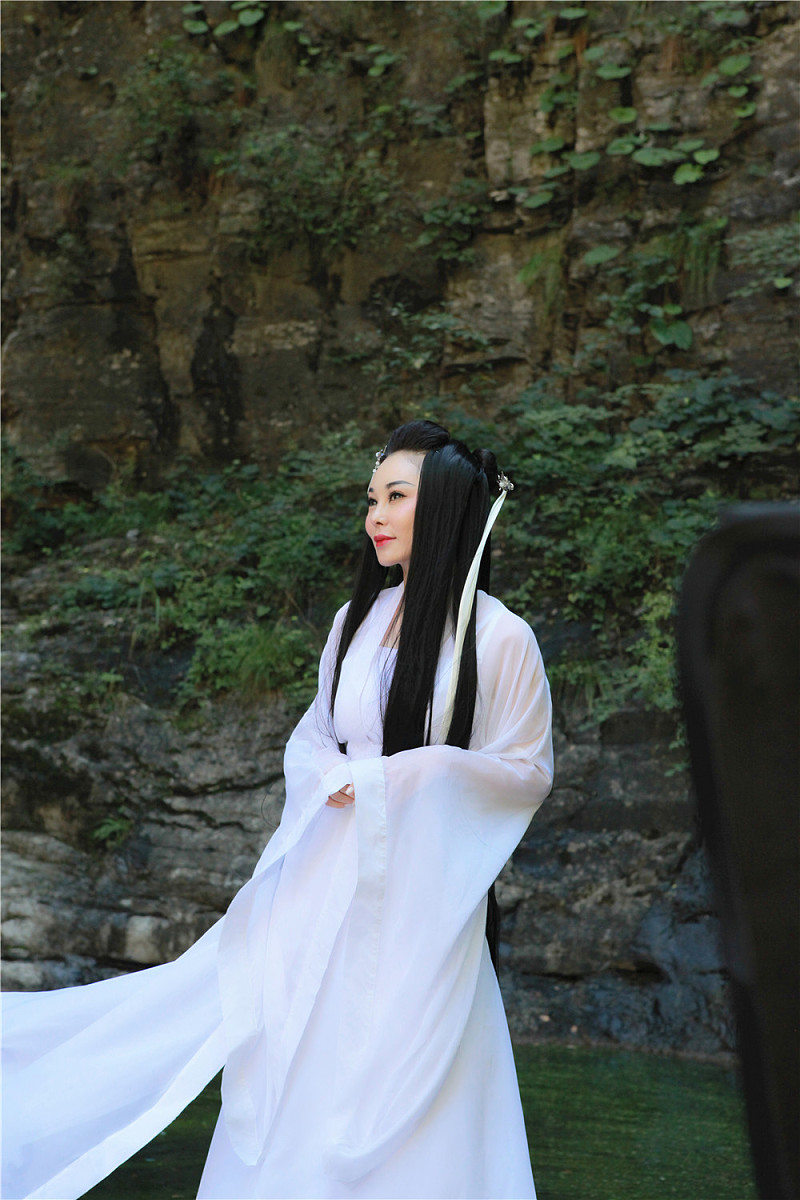 生成描述故事场景一个2女对打的古装武打玄幻背景的地点山林边小溪旁女子仙气飘飘