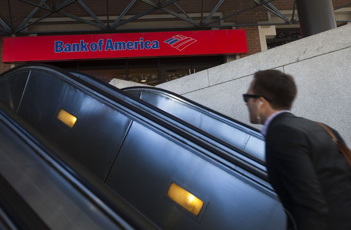 a man rides an escalator near a bank of america branch in arling