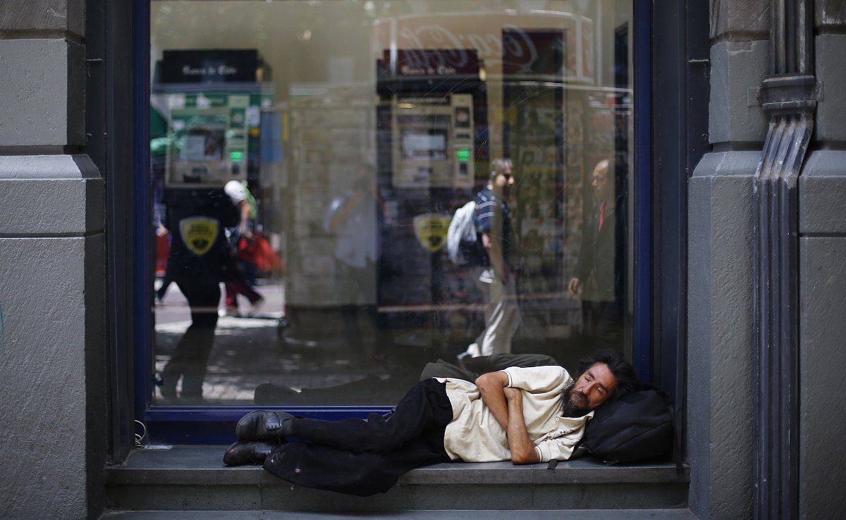 a man sleeps outside a bank branch office in downtown santiago n