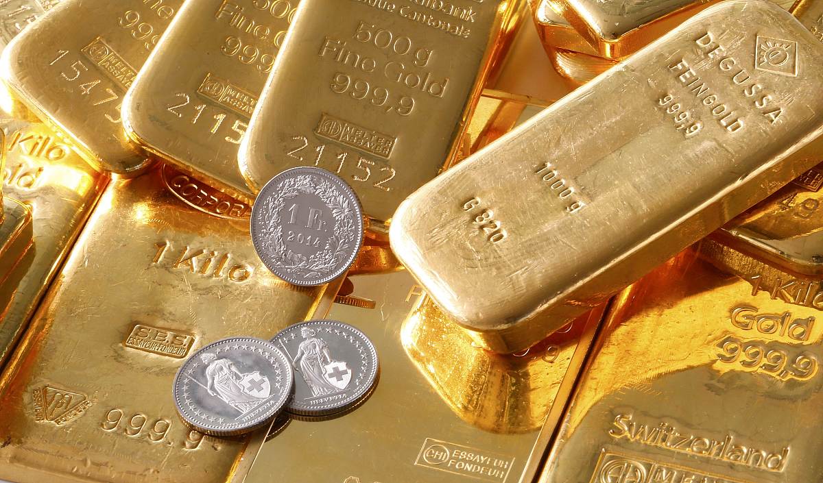 gold bars from the vault of a bank and swiss one franc coins are