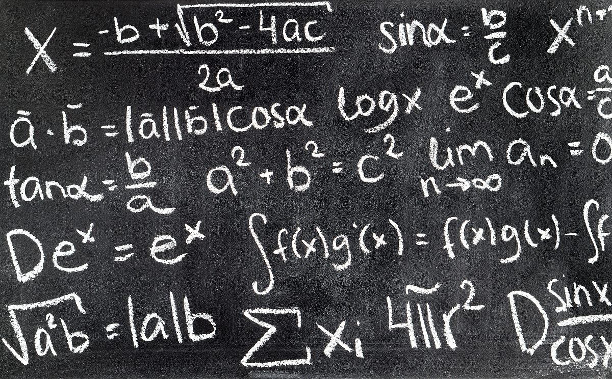 handwritten mathematical formulas on blackboard written with cha