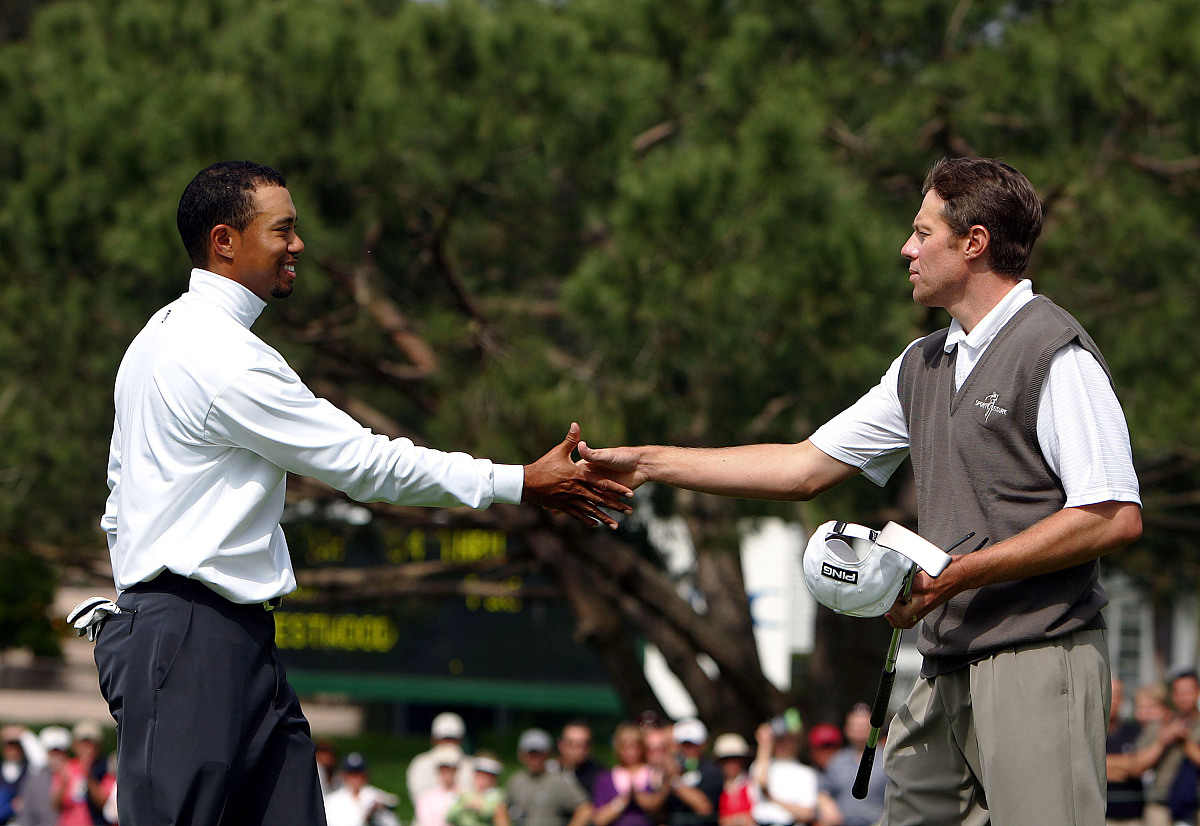 carlsbad, ca - february 25:  tiger woods shakes the hand of nick