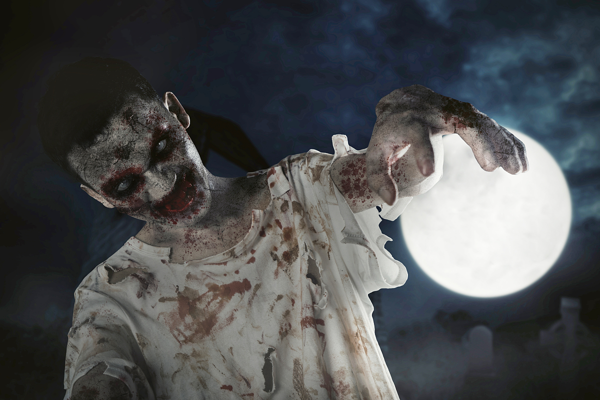 horrible zombie man walking on the grave