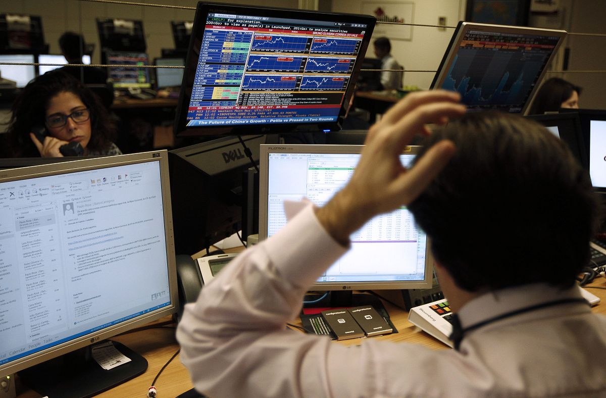 brokers work in a bank's market room in lisbon on february 11, 2