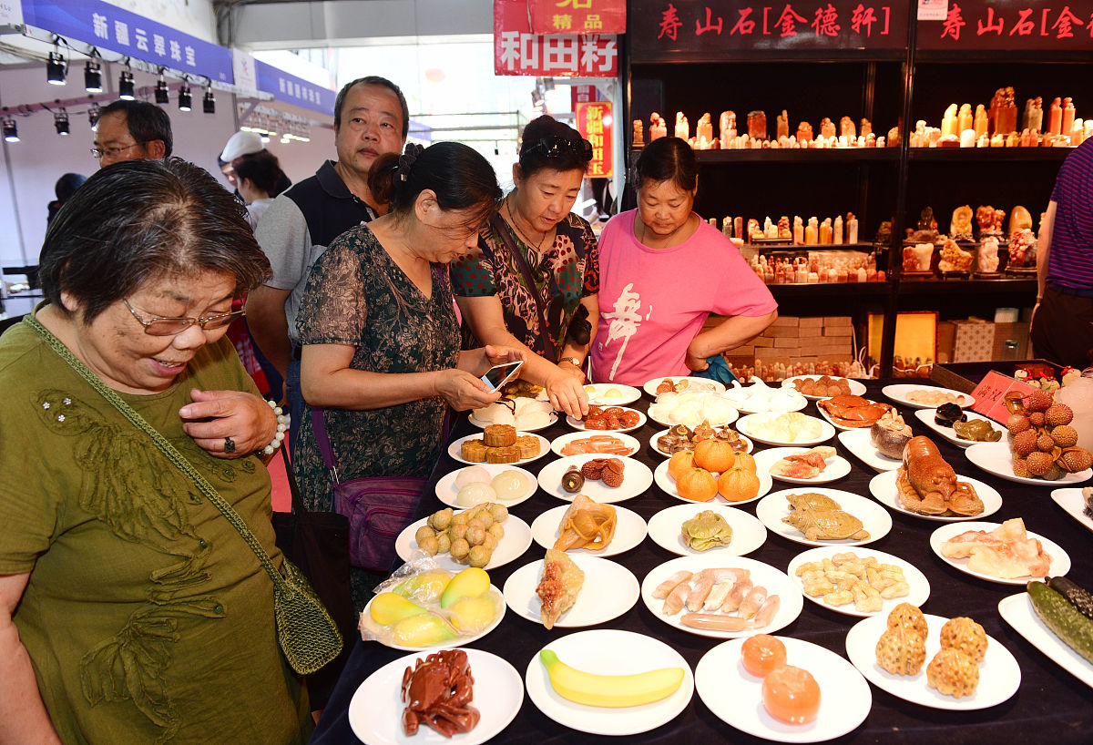 2018年6月15日,江苏扬州,展会上市民观看展览,玉器,漆器,瓷器等展品吸