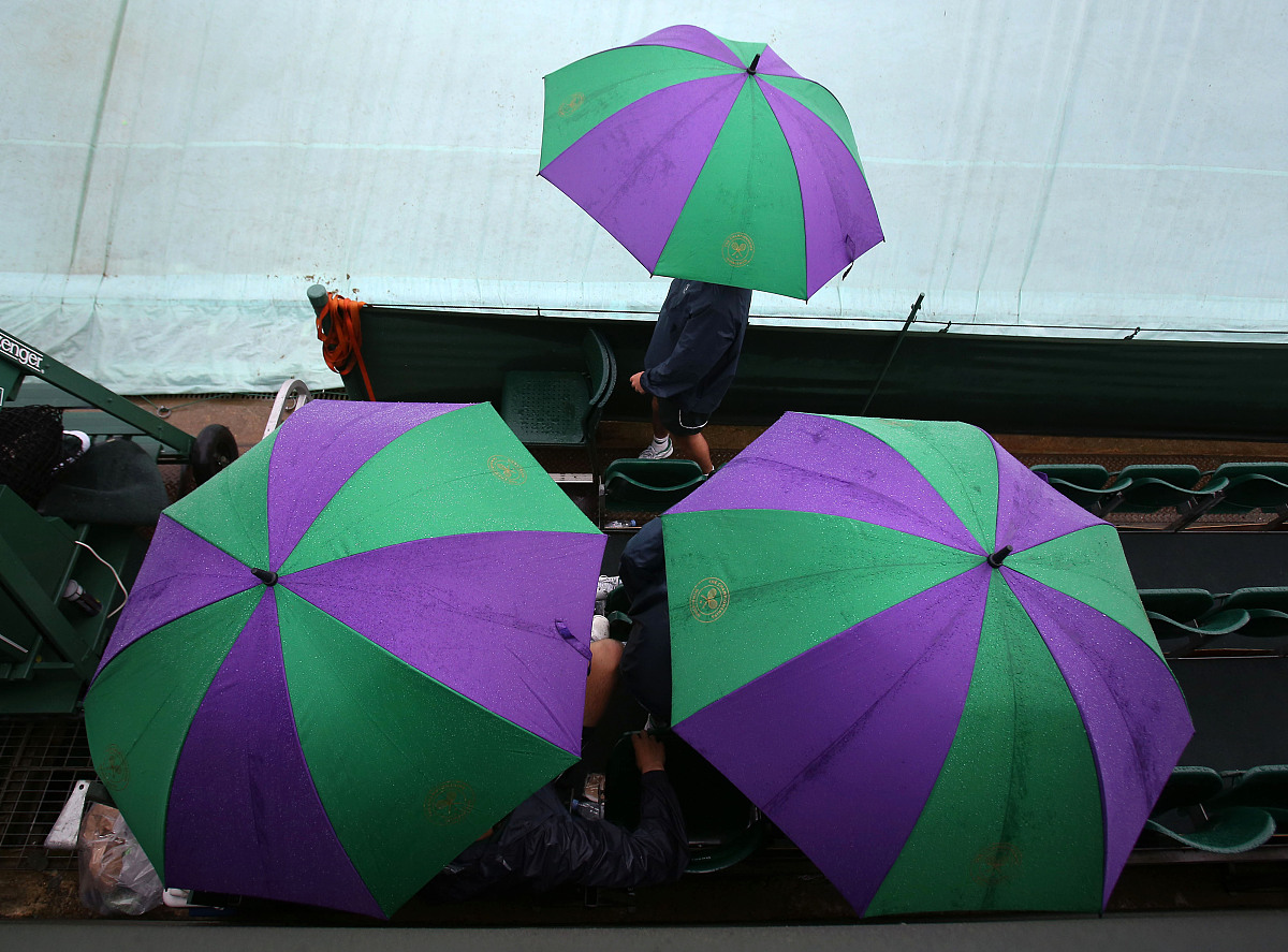 ball boys and girls wait out the rain on court 19 on day six of 