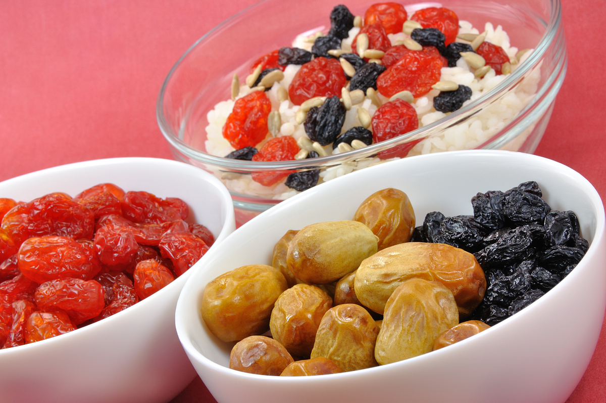 three bowls with rice and dried fruit