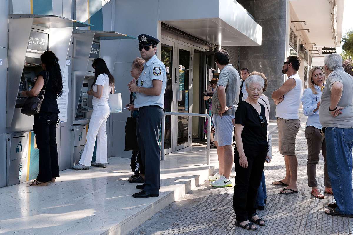 ***_***a policeman guards outside of a bank in central athens on