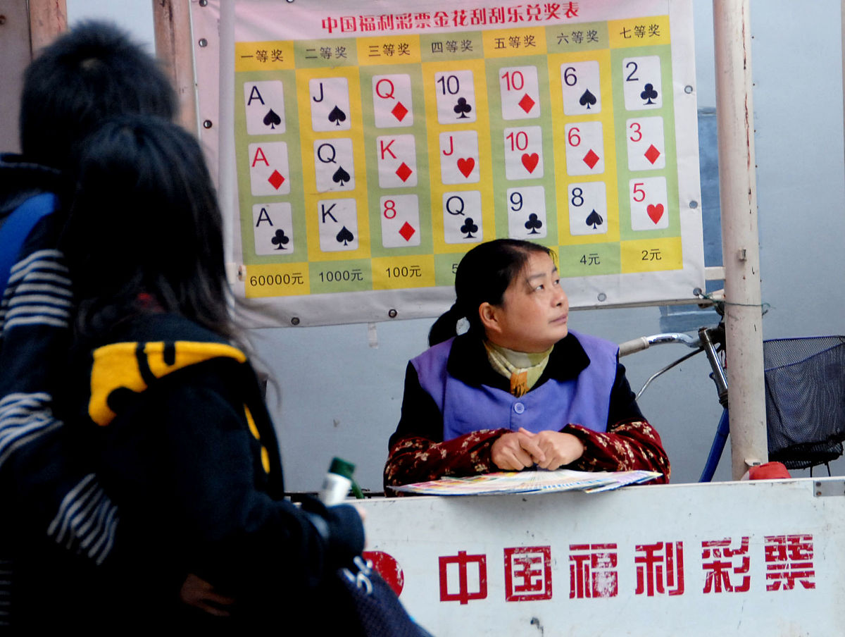 2008年11月9日,上海市民正在南京东路福利彩票销售点购买彩票.当日起,