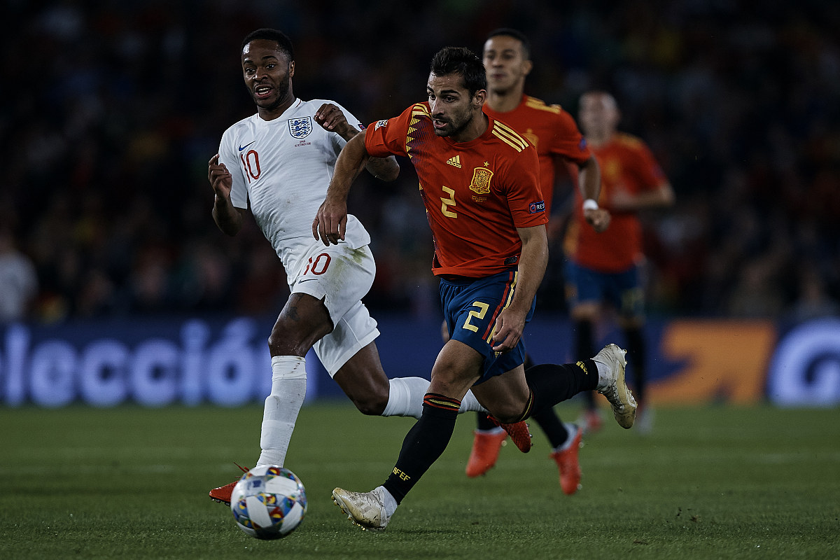 jonny (c) of spain competes for the ball with raheem sterling of