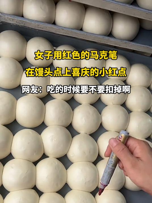 女子用红色的马克笔,在馒头点上喜庆的小红点