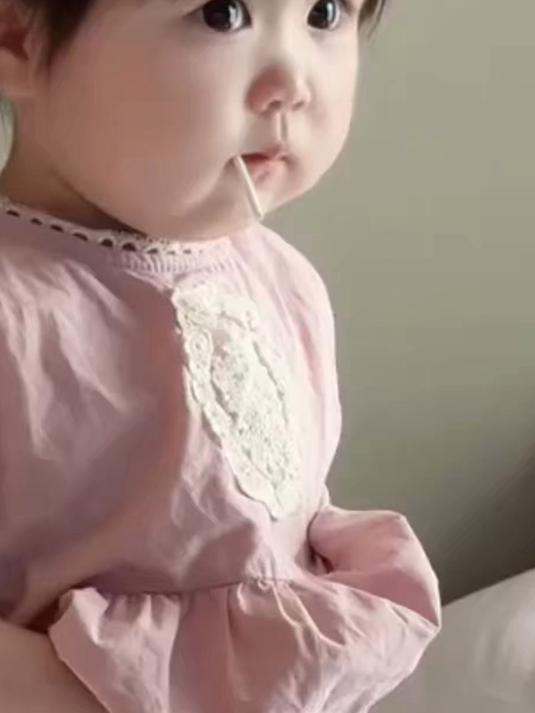 小女孩吃着棒棒糖,挺着小肚子,模样可爱极了