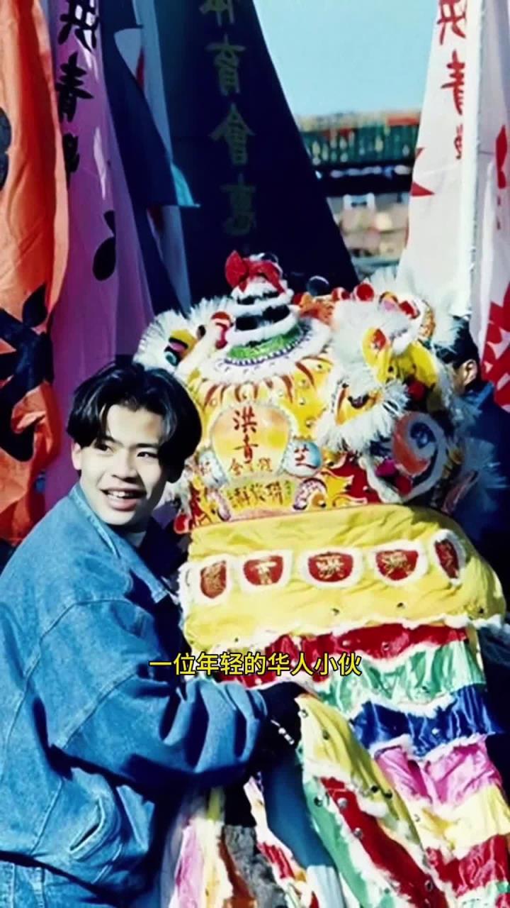 1985年的春节，在芝加哥，一位年轻的华人小伙正站在一个狮子头旁边合影