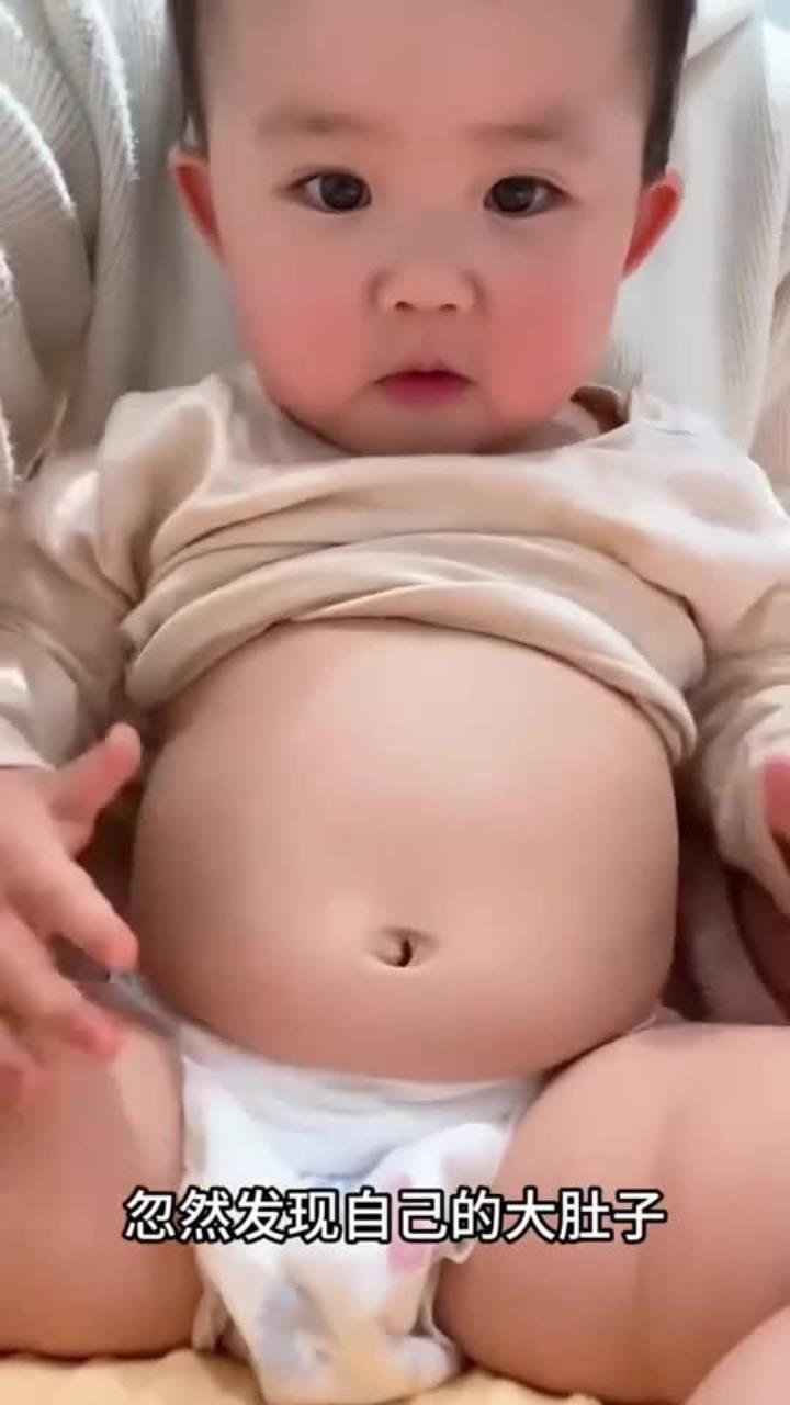 萌宝对着镜子发现大肚子，捏着肚子可爱表情引人发笑 (1)
