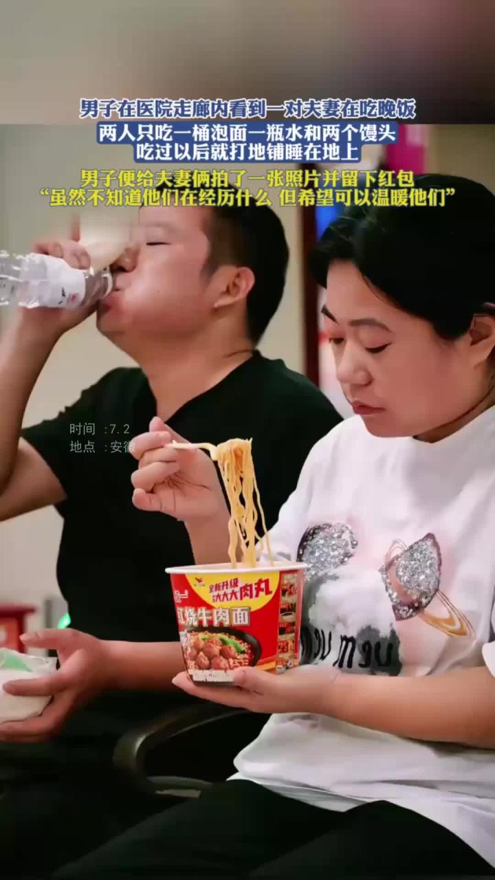 在医院走廊内一对夫妻在吃晚饭,两人吃一桶泡面一瓶水和两个馒头
