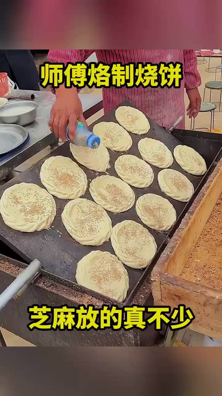 师傅烙制烧饼,芝麻放的真不少!(1)