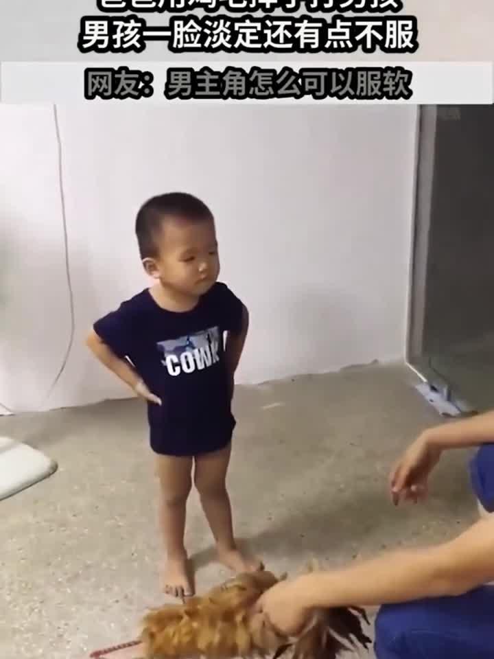 爸爸用鸡毛掸子打男孩，男孩一脸淡定还有点不服