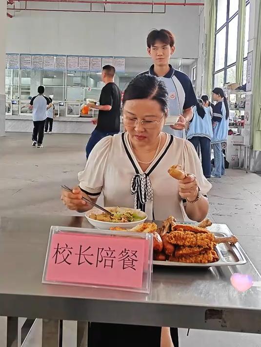 校长陪餐，同学们偷吃她手里的鸡腿，一人拿一个，不小心被发现了