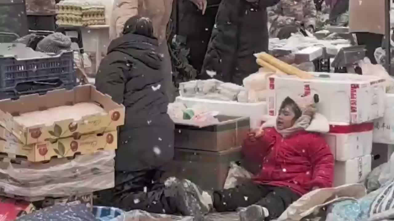 小朋友陪妈妈在雪地卖菜,即使满身都是雪依旧开心的不得了