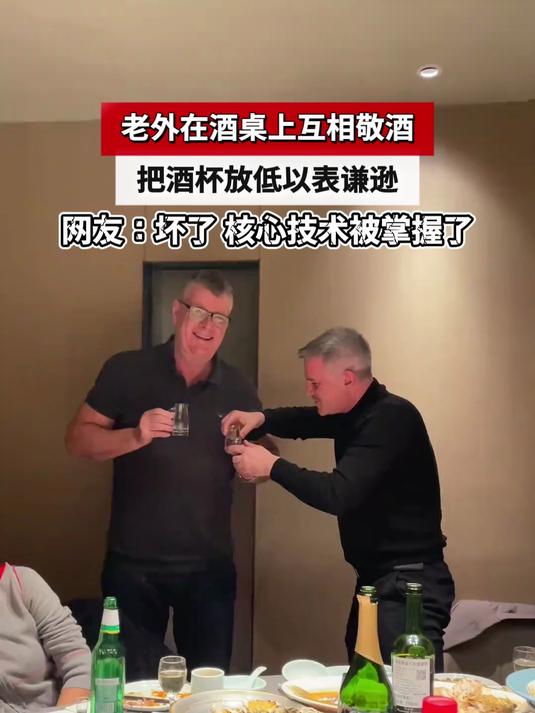 老外在酒桌上互相敬酒,把酒杯放低以表谦逊