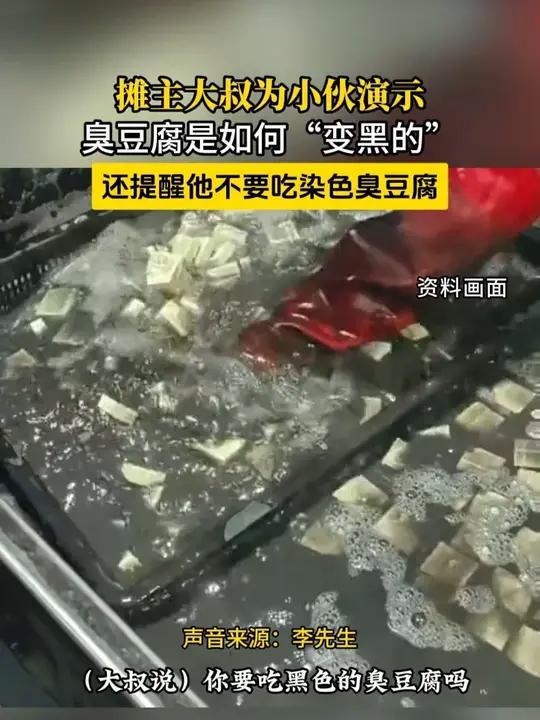 广东广州。摊主为小伙现场演示臭豆腐是如何“变黑的”