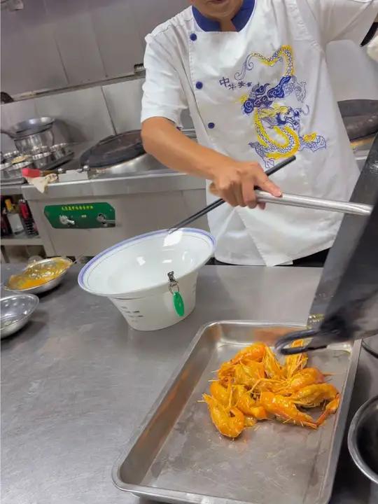 (檀岛汁烧罗式虾)胸部齐头开刀,修剪一下,八层油温下锅胸部开刀处更丰满,定型出锅备用。复合