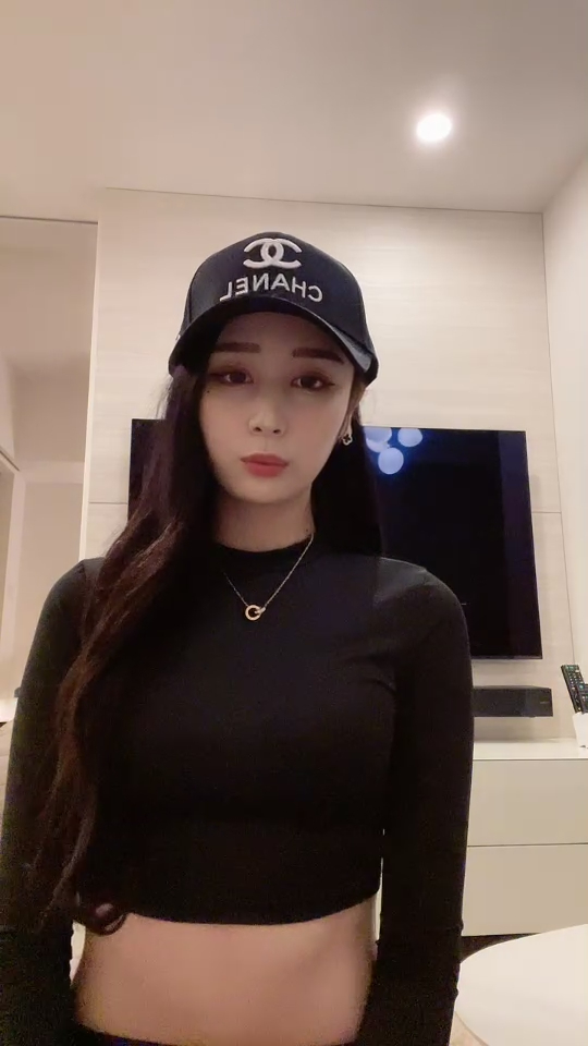 身穿黑色半腰衣服,头带帅气鸭舌帽,美女的时尚穿搭