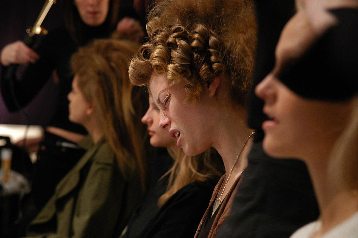 new york - february 11:  models get ready backstage at the bahar
