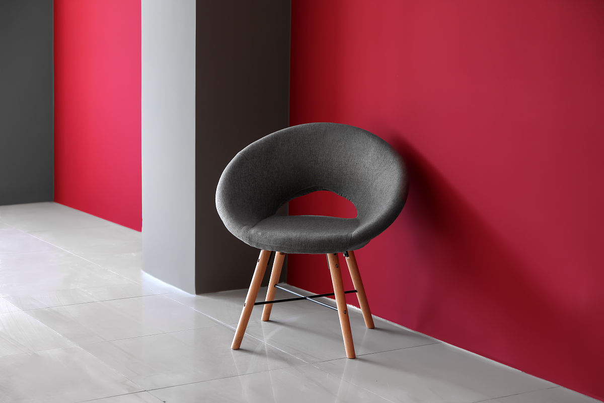 comfortable chair near color wall