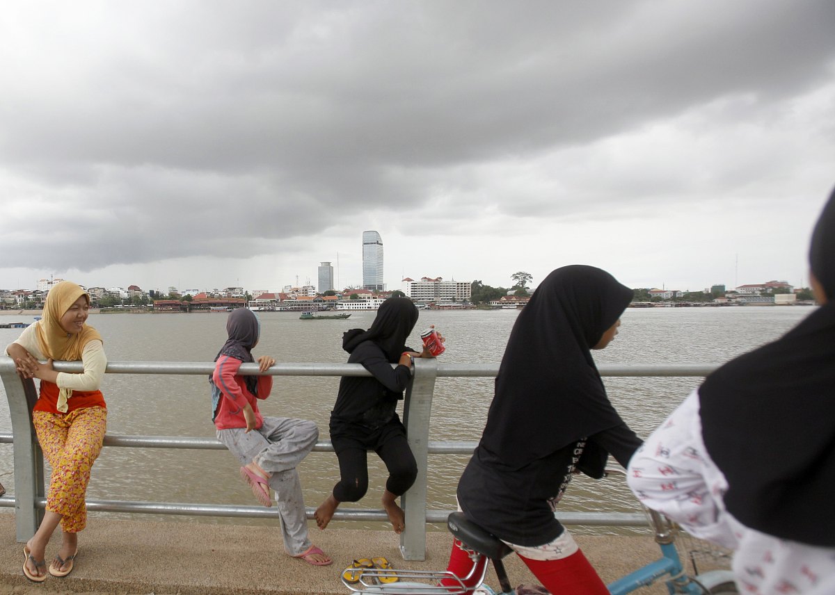 ethnic cham muslim girls play on a bank along the tonle sap rive