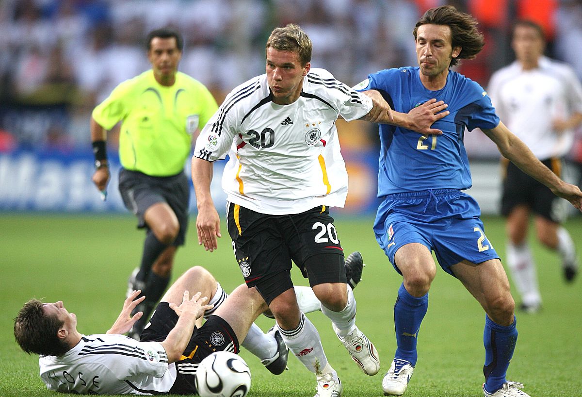germany's lukas podolski (c) and italy's andrea pirlo (r) battle