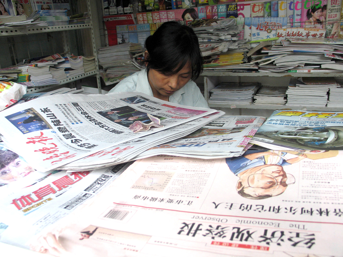 2005年8月8日,山东聊城邮政局报刊发行部的员工在分发报纸.+++_+++报