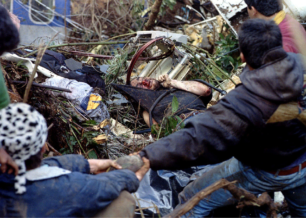 rescue workers try to remove the body of a victim december 22 of