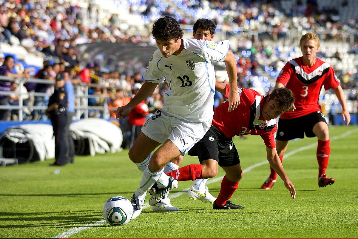 pachuca, mexico - june 19:  juan cruz (l)  of uruguay struggles 