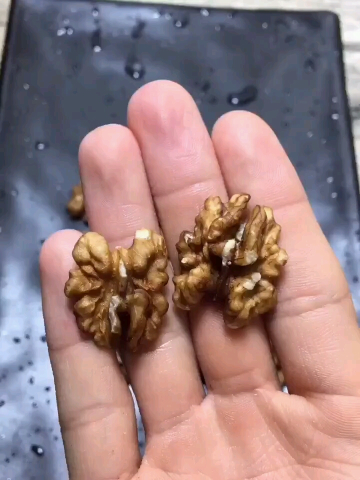 琥珀核桃仁做法:核桃仁火炒熟,锅烧水放白糖熬化,熬制香油色加核桃仁