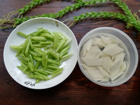 將芹菜斜刀切成寸段,山藥切成菱形片,放在水中,加入幾滴醋,防止山藥