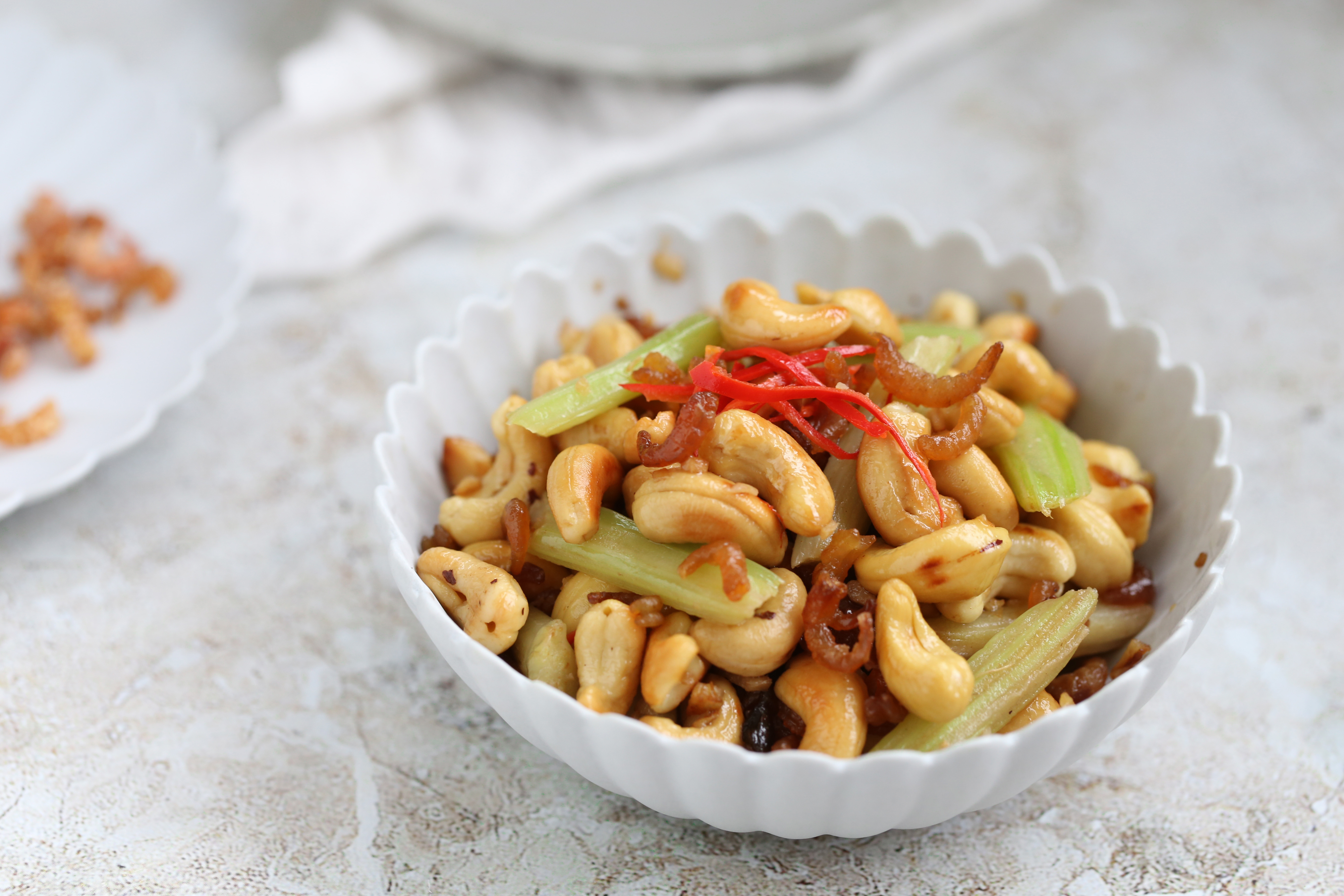 热锅冷油加入腰果,开小火不停翻炒,直至腰果变成金黄色,沥油待用.